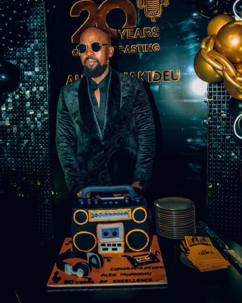 Alex Mwakideu poses with his beautiful and creative radio cake to mark his 20 years in radio. Photo: Alex/Mwakideu/Facebook