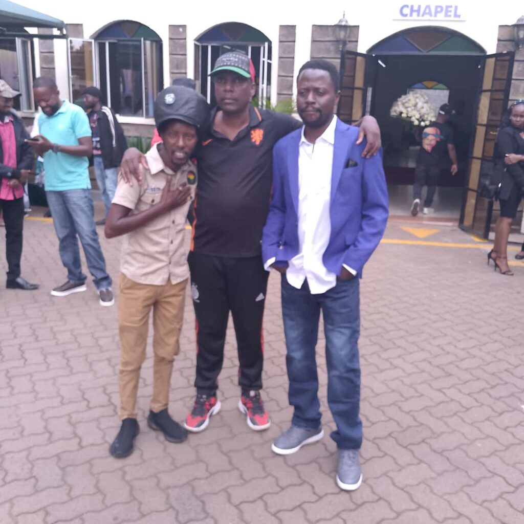Mbusii, Diamond Okusimba consoling their fellow collegue at Radio Jambo Lion Deh at Montezuma Funeral Home during the memorial service of his son. Photo: Courtesy