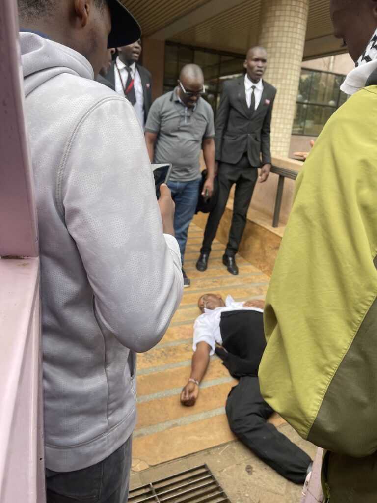 Kenya Power security guard lies on the ground after being shot at Stima Plaza in Nairobi during the Gen Z protests on Wednesday, June 25, 2025.