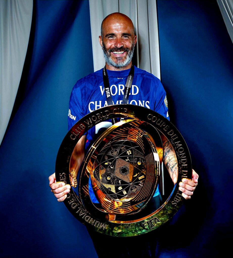 Chelsea Manager Enzo Maresca all smiles as he poses with the FIFA Club World Cup trophy after their historic win. Photo: X